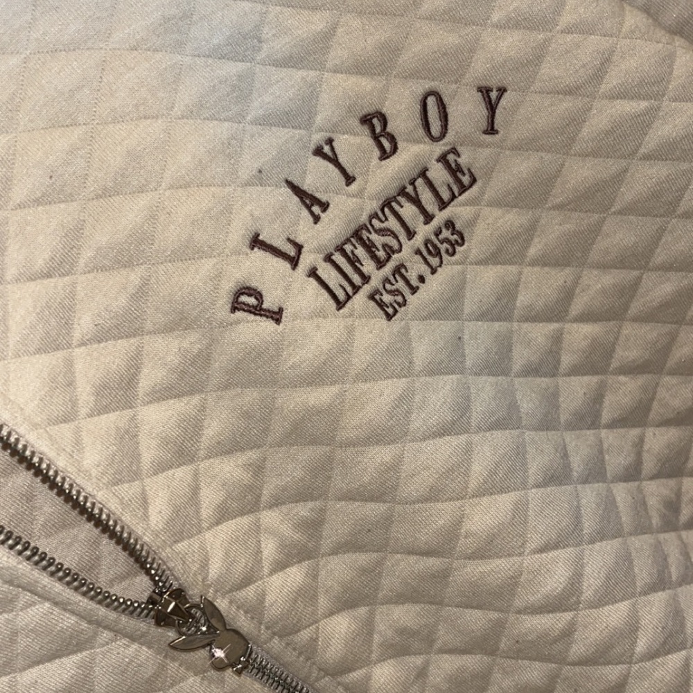 Playboy bomber jacket with limited cubic zirconia zipper pull